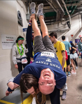 Alex Moon, a senior majoring in political science and psychology, is supported by Alana Boerlin Class of 2019, to get more blood to his head during THON at the Bryce Jordan Center on Saturday, Feb. 22, 2020 Moon is dancing for Lion Ambassadors. ( 2:45 pm  Saturday) Photo by Caitlin Lee